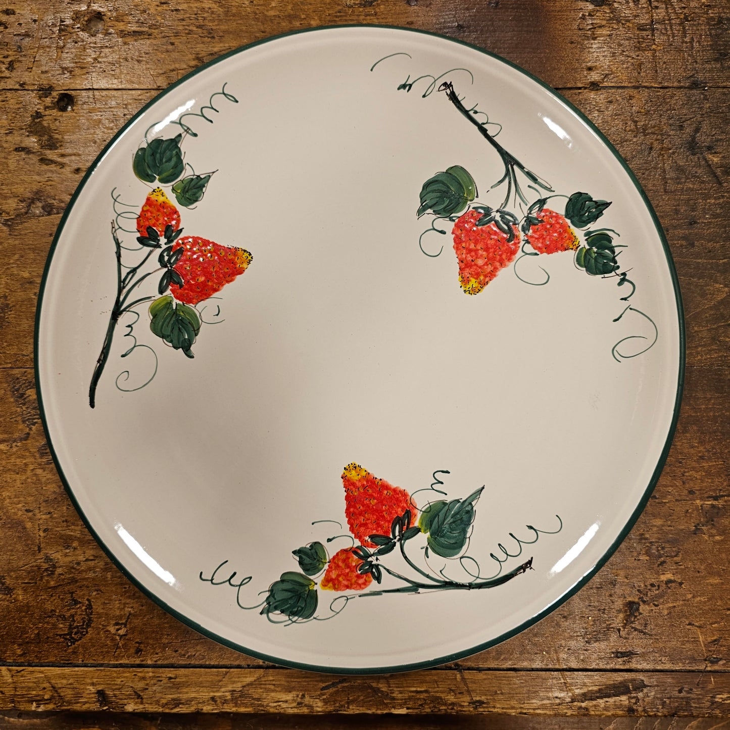 Round ceramic serving plate decorated with strawberries