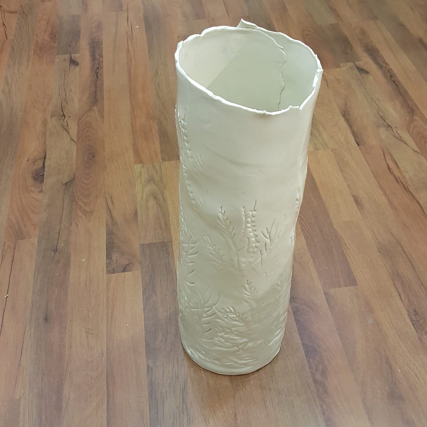 White porcelain vase with floral pattern imprint