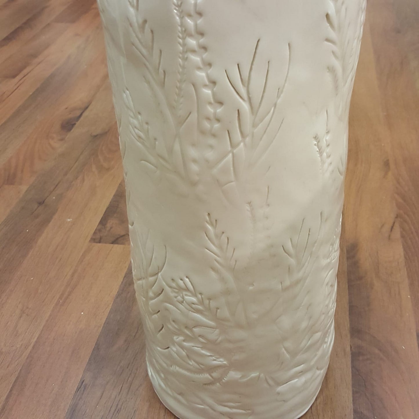 White porcelain vase with floral pattern imprint