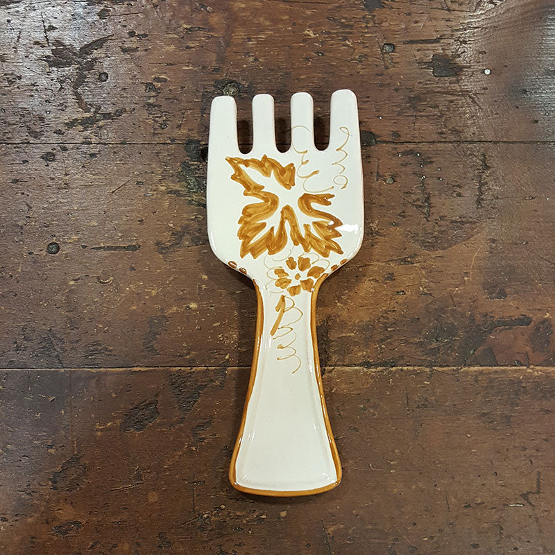 Fork-shaped kitchen spoon rest in ceramic