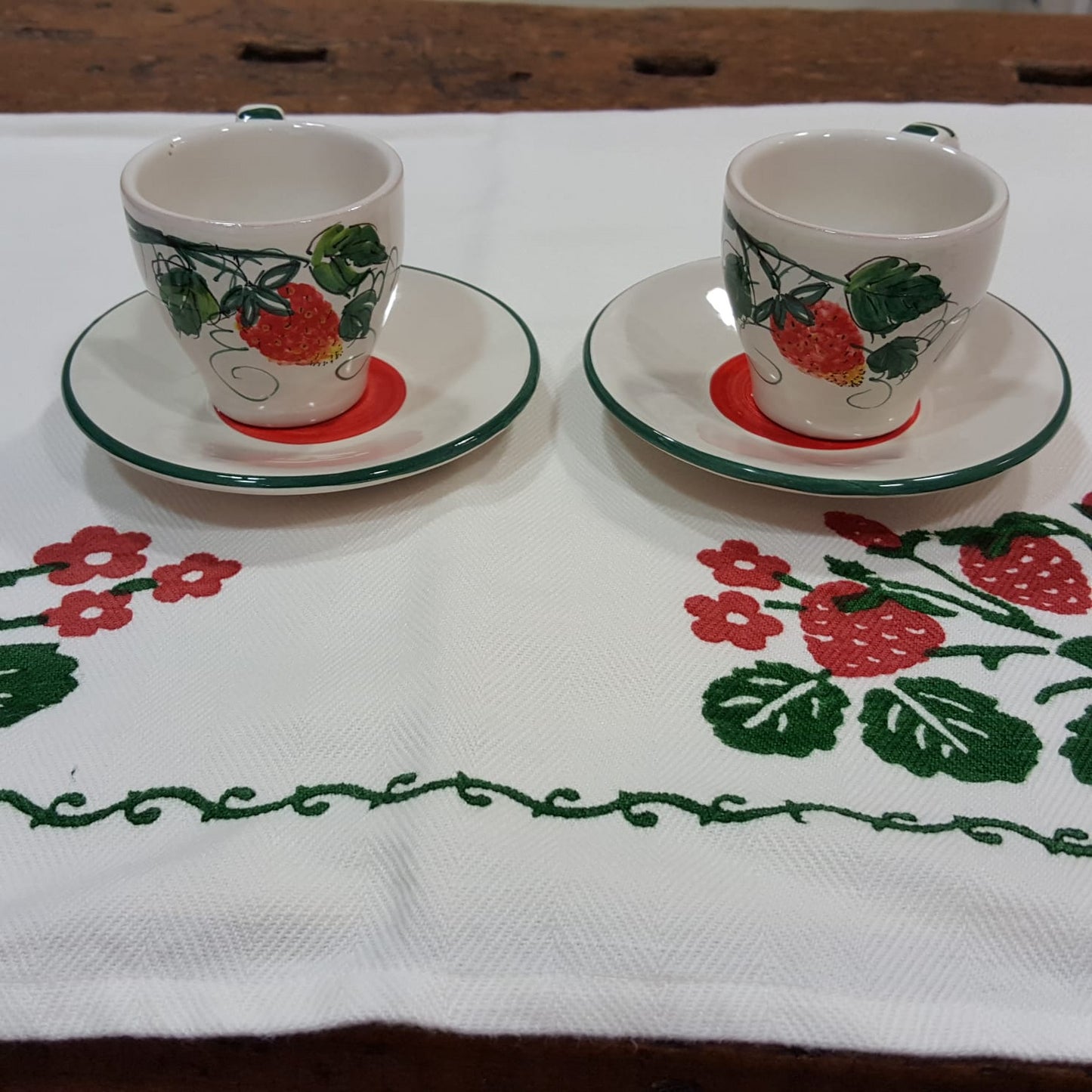 Hand painted ceramic coffee cups with strawberry decorations