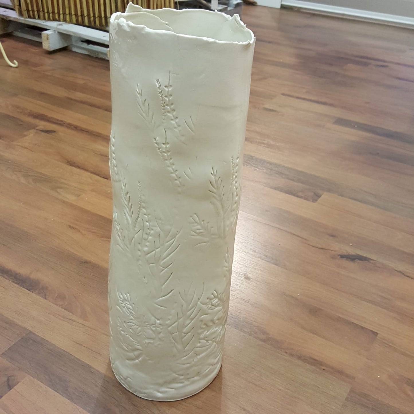 White porcelain vase with floral pattern imprint