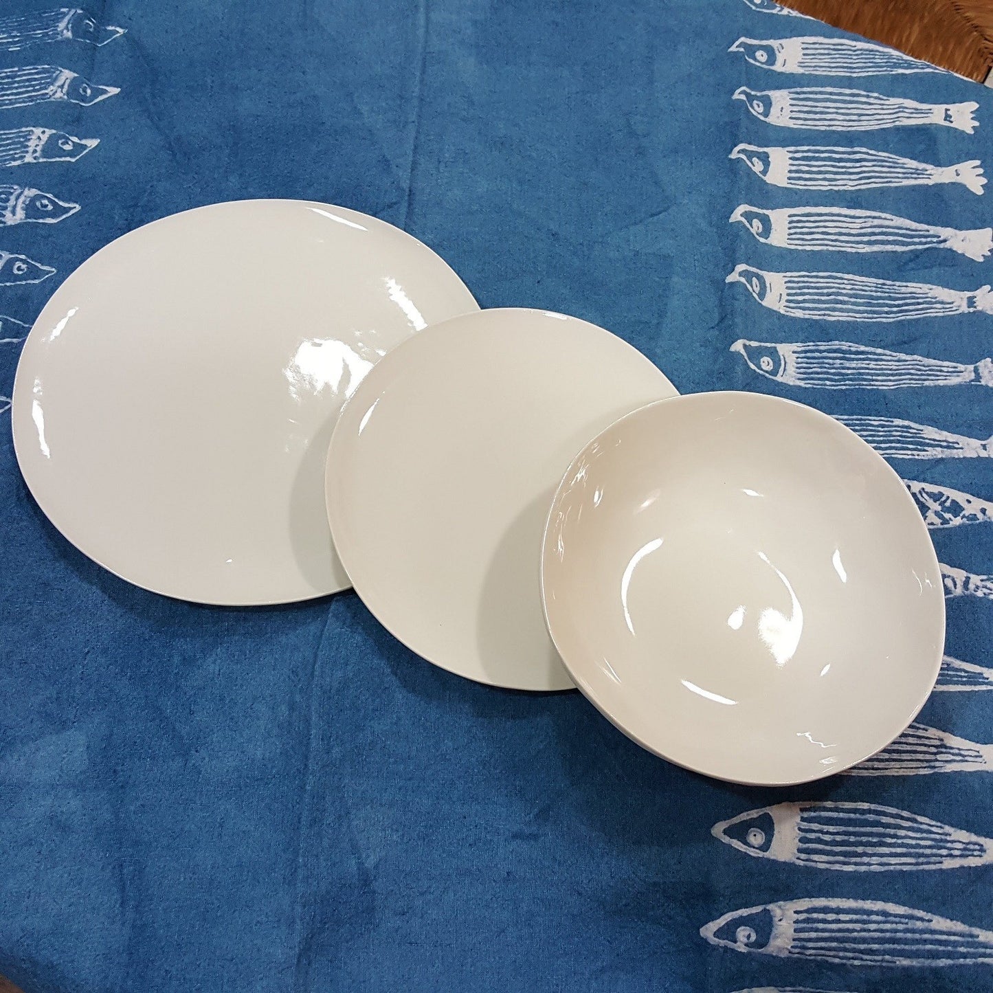 Plates set in shiny white porcelain handmade